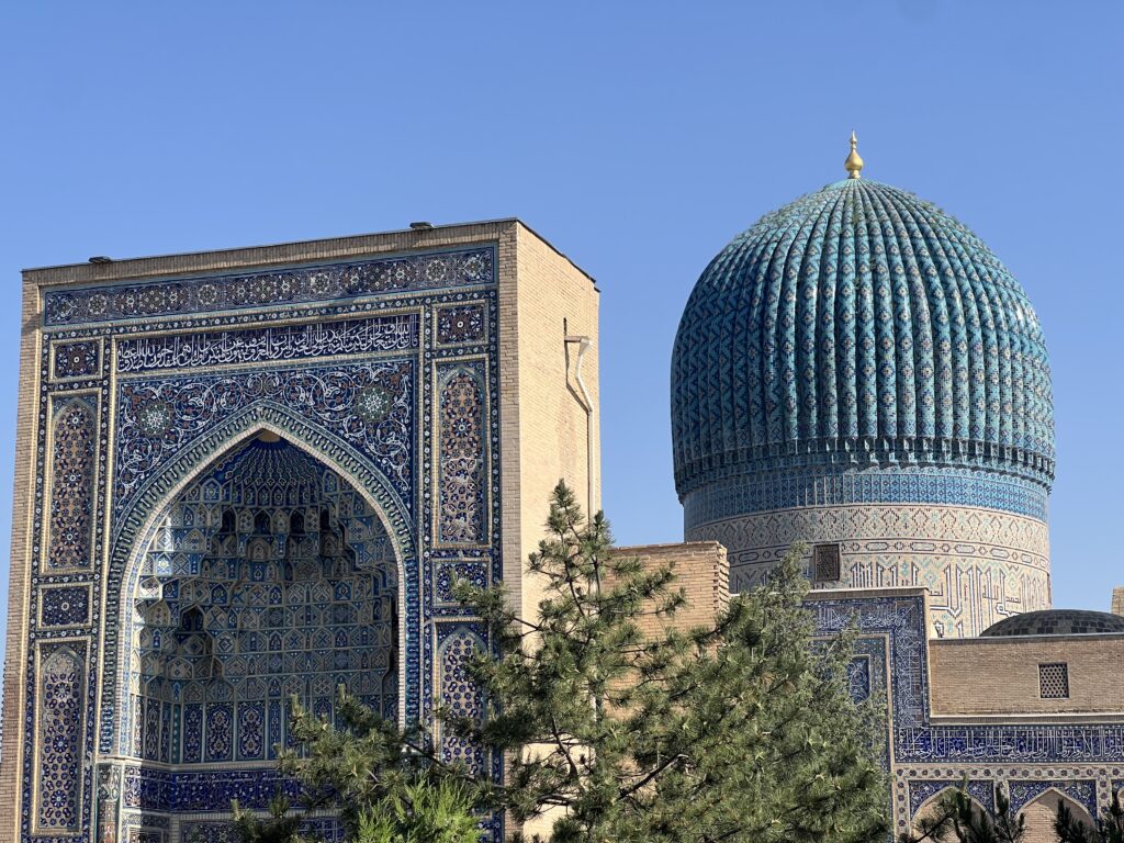 Close-up of the turquoise dome and intricate blue tilework of the Gur-e-Amir Mausoleum in Samarkand, Uzbekistan, showcasing Islamic architecture.